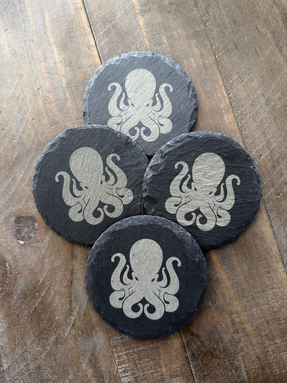 How do you make an octopus laugh? Ten-tickles! Enjoy a beverage while protecting your tabletops with these octopus themed slate coasters! The images are laser engraved onto each slate coaster and are permanent. They won't fade or wash off! Grab a set for that perfect groomsman or house warming gift. These slate coasters will also be right at home in any man cave or she shed. Makes a great holiday present or stocking stuffer, too! Coasters include padded feet attached.