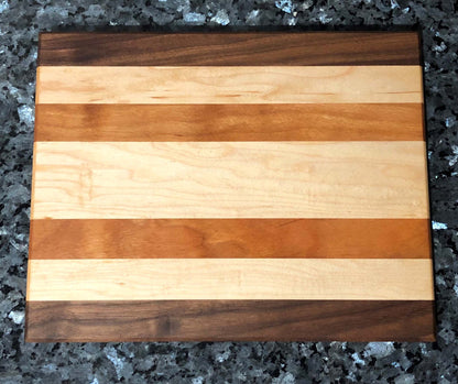 Long grain cutting board. Features black walnut, maple, cherry hardwoods.