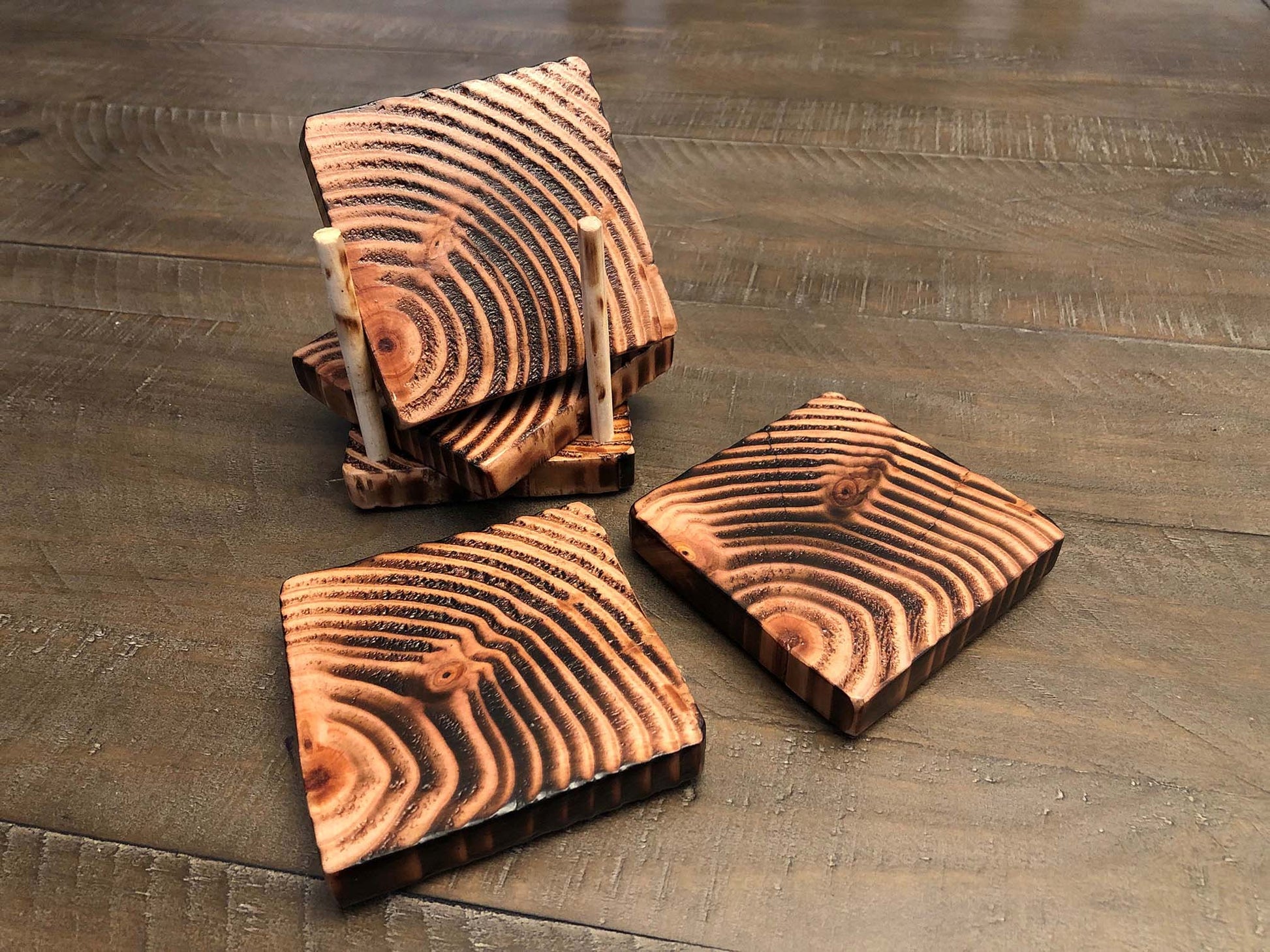 Rustic farmhouse wood coasters. Natural end grain pattern. Charred, burned and distressed. Patriotic red, white and blue distressed and burned.  Set of 4 coasters and holder includes felt food pads. Handmade by Space Rubber Ducky Designs.
